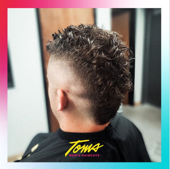 A man with a textured mullet.